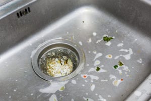 Close up dirty sink or basin with foodwaste after wash dishware